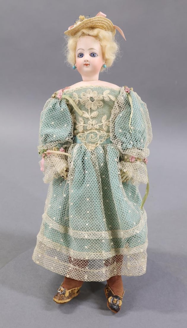 ANTIQUE FRENCH FASHION DOLLS.: 10 1/2" Doll marked "F.G." on left shoulder, "3/0" on back of head and right shoulder. Socket head on a separate bisque shoulder plate. Blue paperweight eyes, closed mouth, pierced ears, pale blonde