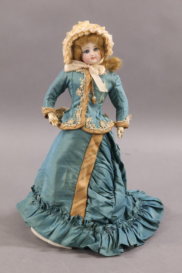 ANTIQUE FRENCH FASHION DOLLS.: 12" Doll marked "F.G" on left shoulder and "0" on back of head. Socket head on a separate bisque shoulder plate. Blue paperweight eyes, closed mouth, pierced ears, honey blonde mohair wig, cork pate. 