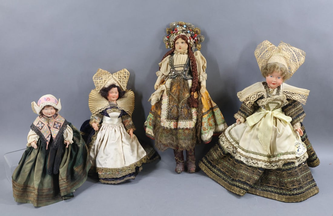 DOLLS REPRESENTING OTHER COUNTRIES.: LOT of all original costume dolls. (3) French Celluloid dolls dressed in Provincial costumes. All of them have painted features, mohair wigs, 5 pc. bodies with painted shoes, socks. 10", 10". 13"