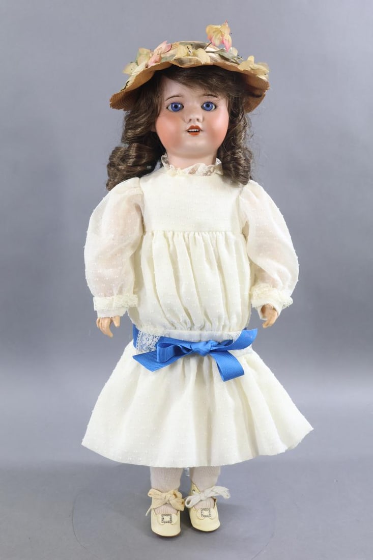 ANTIQUE FRENCH BISQUE DOLLS.: 21" 21 SFBJ 60 PARIS 6 doll with stationary blue eyes, open mouth, brown HH wig. Papier mache jointed body. Dressed in vintage dotted Swiss drop waist dress, cotton underwear. Ivory oilcloth shoes.