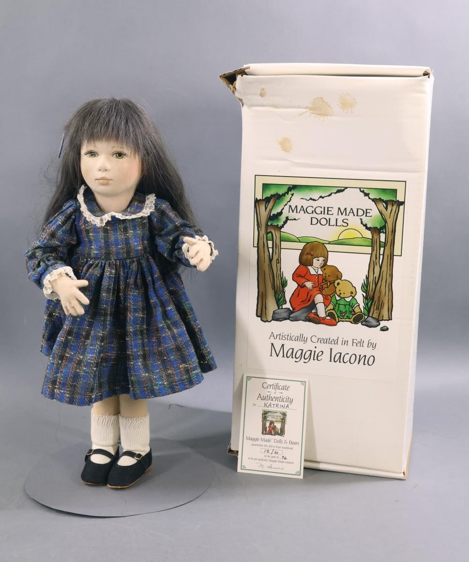 MAGGIE IACONO.: 16" All original "Katrina" doll, 12/20, in original box. Black HH wig. COA. Condition: moth damage on back of right leg. Age loss on box. This lot is being sold AS IS.