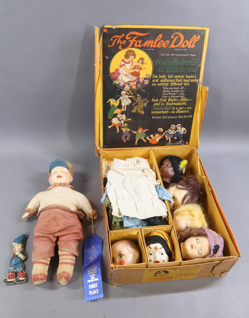 FAMLEE DOLL SET.: LOT. Patented April 12, 1921 - Composition FAMLEE Set of doll with (7) heads, (7) outfits in original box. Made by the Berwick Doll Co.Comes with advertising and information sheets. Condition: no