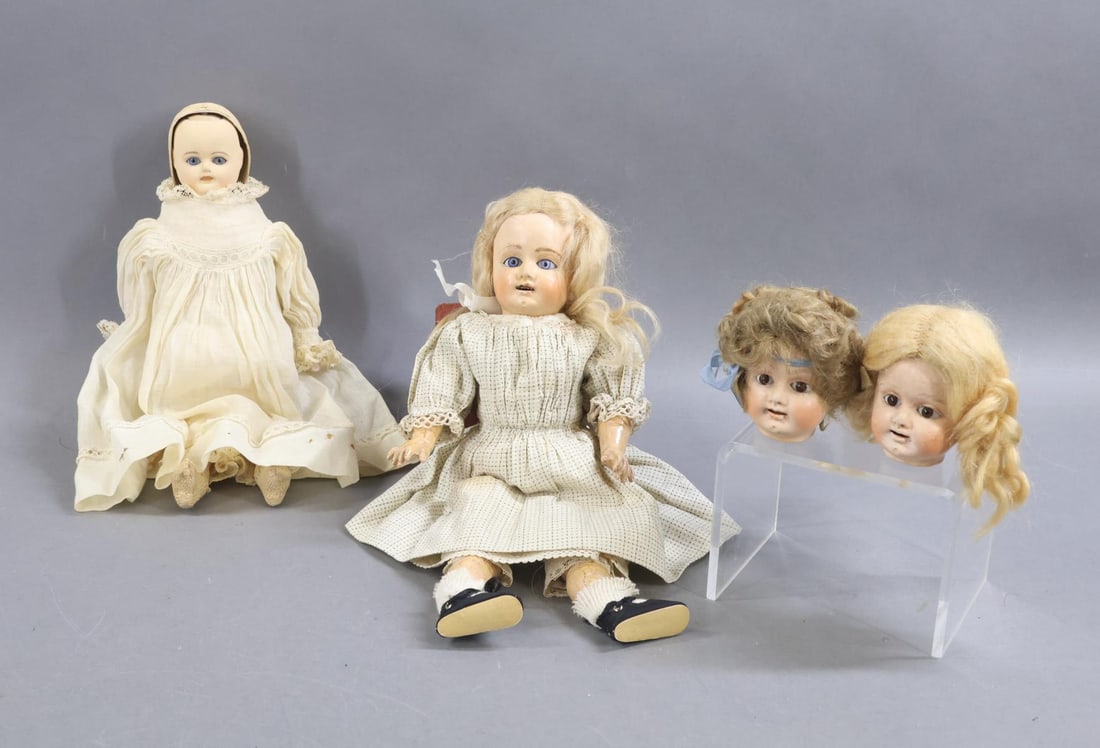 MULTI FACE/HEAD DOLLS.: Pair of German dolls with papier mache heads. Doll 1) 12" unmarked shoulder head has two faces, both with stationary blue glass eyes. Pleasant face and upset face. Head is encased in a hard hood but