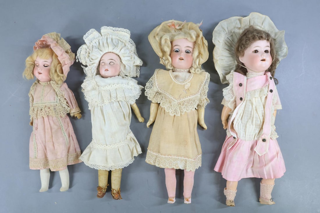 GERMAN BISQUE DOLLS.: LOT of (4) dolls in their original factory outfits.(3) Have sleep eyes, the other stationary. They all have open mouths and mohair wigs, (3) original paper shoes . 13" AM 390 has no paper shoes. 14"