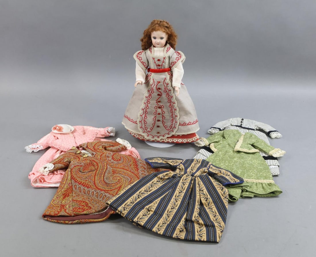 ARTIST FRENCH BISQUE FASHION DOLL.: LOT. 12" French Fashion Doll signed by artist PJL 06'. Blue paperweight eyes, closed mouth, pierced ears, brown curly mohair wig. Bisque shoulder plate mounted on a reproduction jointed body. Dressed