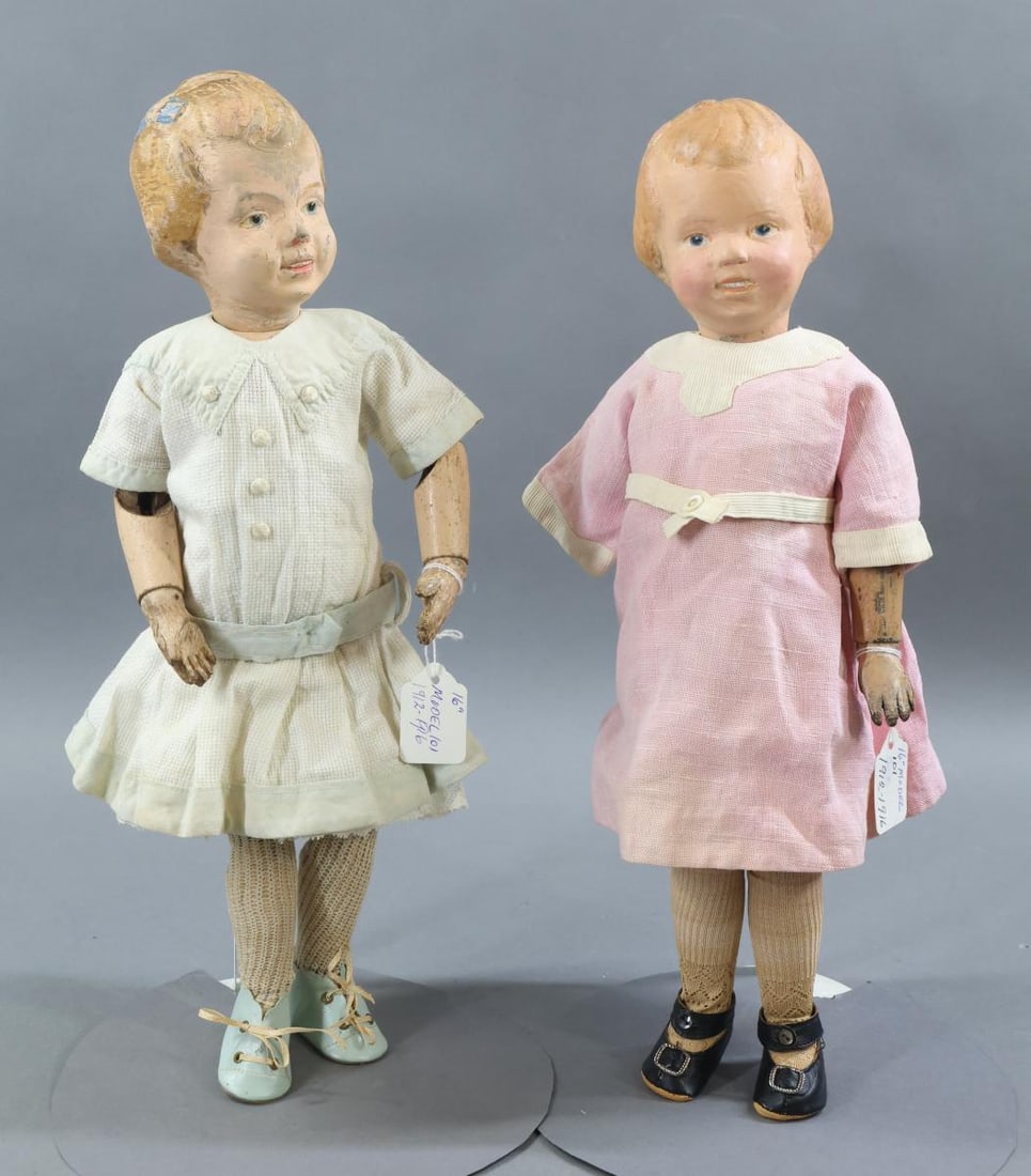 SCHOENHUT.: Pair of 16" Model No. 101 Schoenhut dolls with carved heads. 1912 - 1916. Both dolls have the incised mark on back of torso, blue intaglio eyes, open/closed mouths showing teeth. No original clothing,