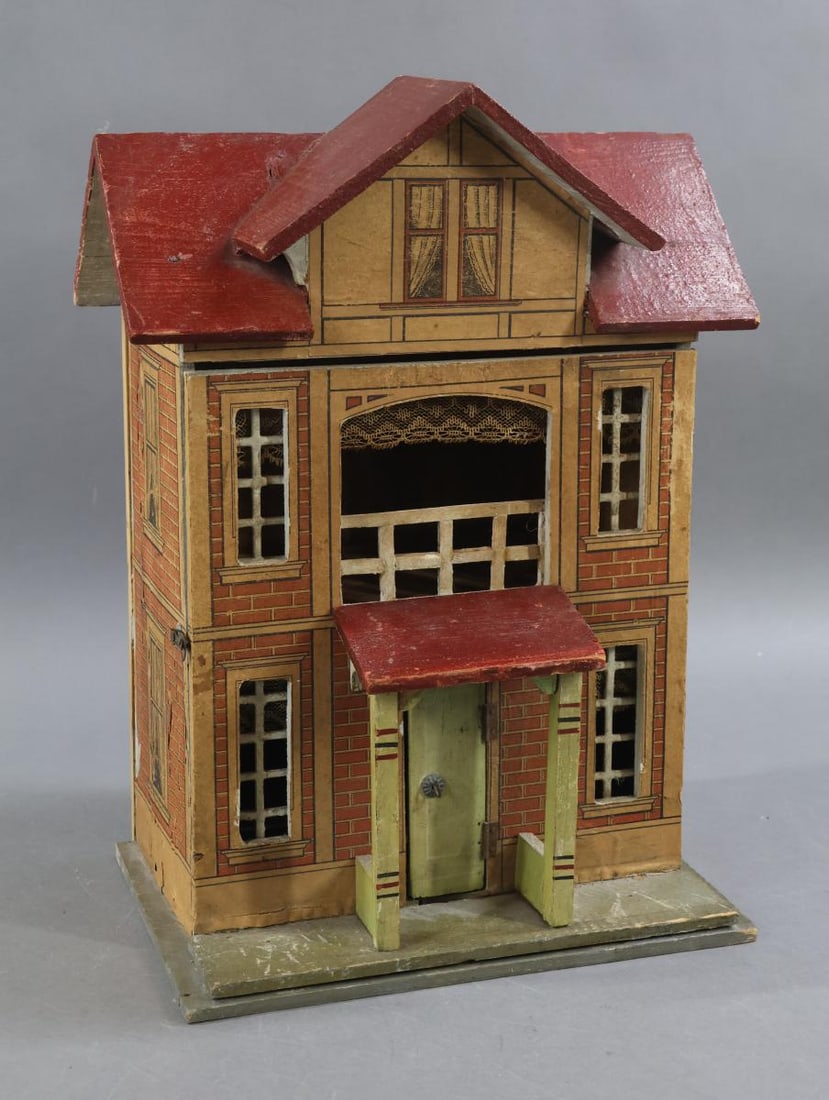 GOTTSCHALK DOLL HOUSE.: Small German GOTTSCHALK Red Roof Doll House No. 4447. Ca. 1908. Both the exterior and interior retain all original details. The facade displays red and white brick papers, painted trim. Hinged front.