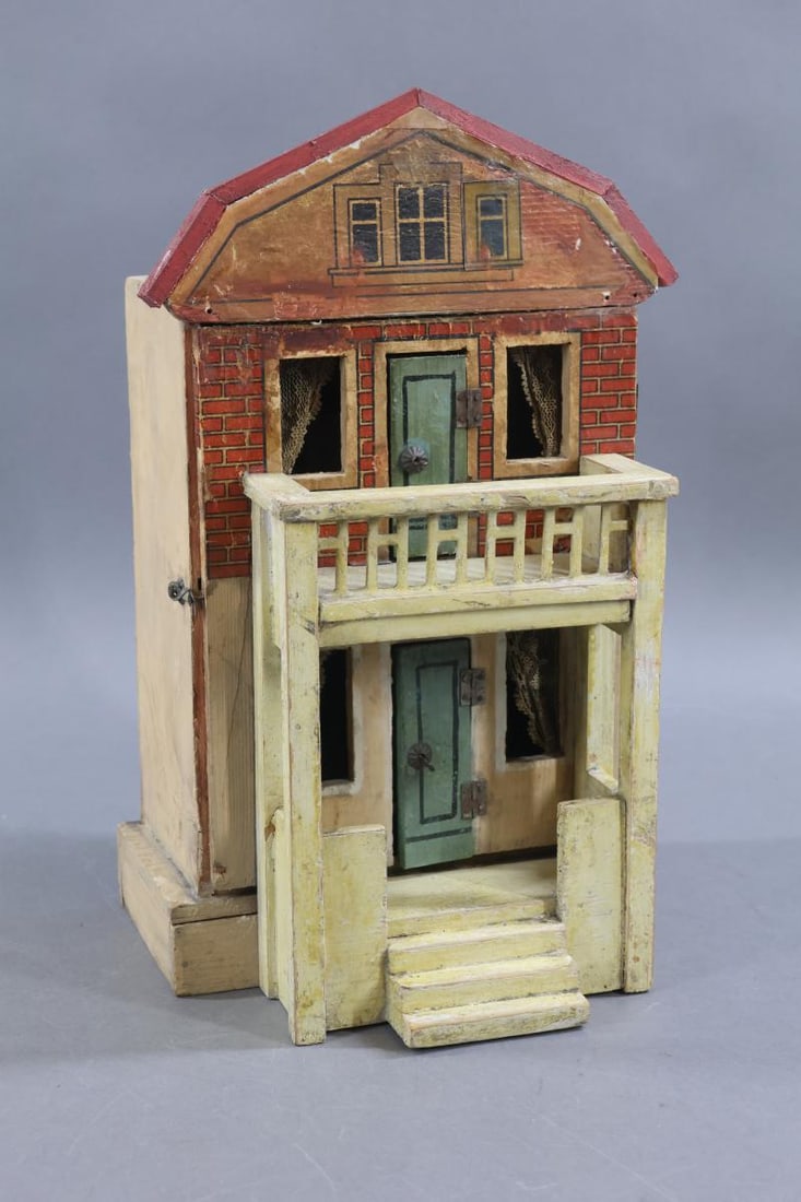 GOTTSCHALK DOLL HOUSE.: Small GERMAN GOTTSCHALK Doll House with faux front gambrel roof. Ca. 1907. Both the exterior and interior retain original details. The facade on the upper half of front displays red and white brick