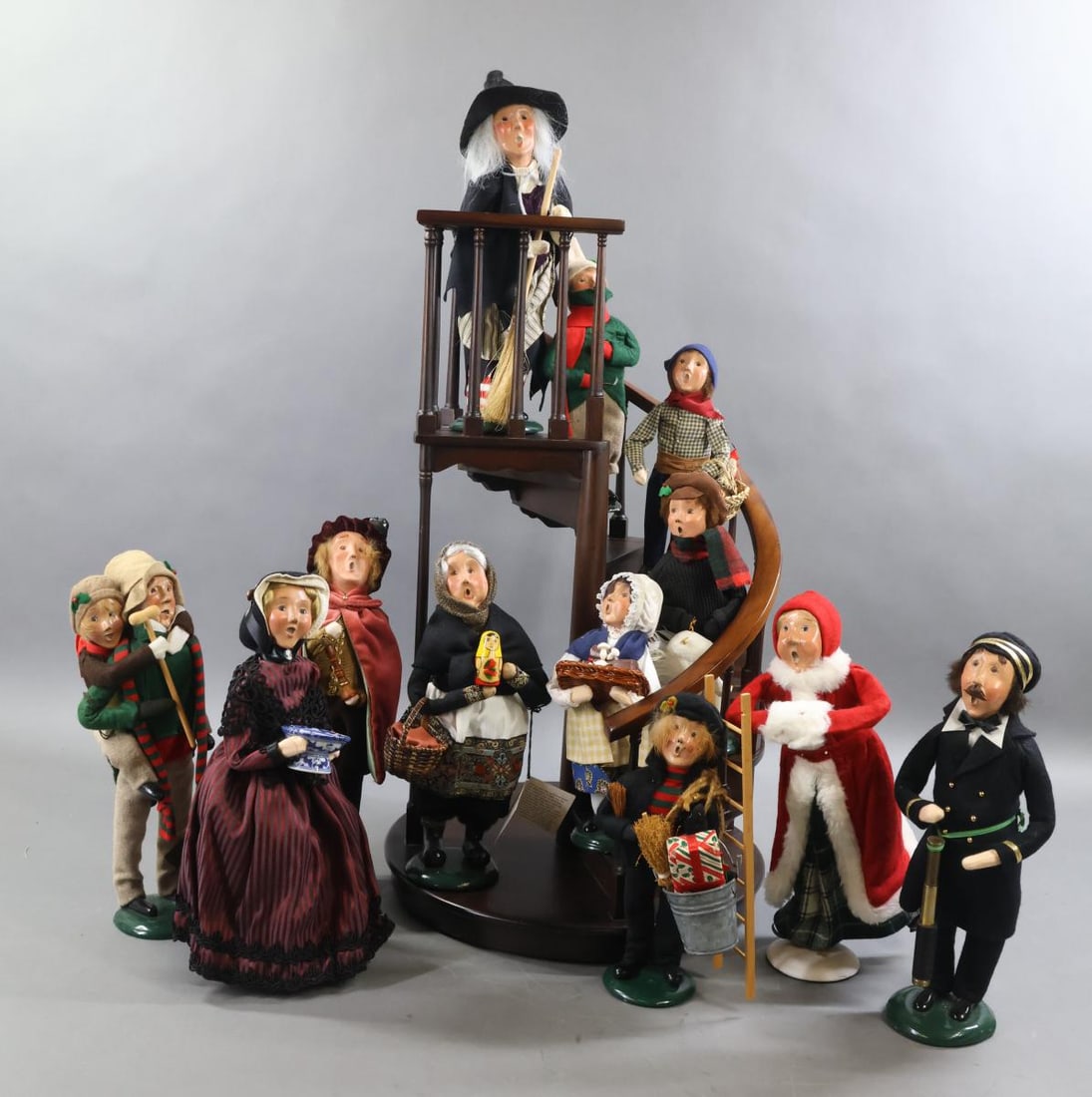 BYERS CHOICE.: LOT of (12) Carolers and wooden staircase. (12) Carolers. Halloween - Witch w/broom. Christmas - Boy w/ Goose. Boy w/candle. Bob Cratchit with Tiny Tim. Chimney Sweep with bucket/ladder. French Boy