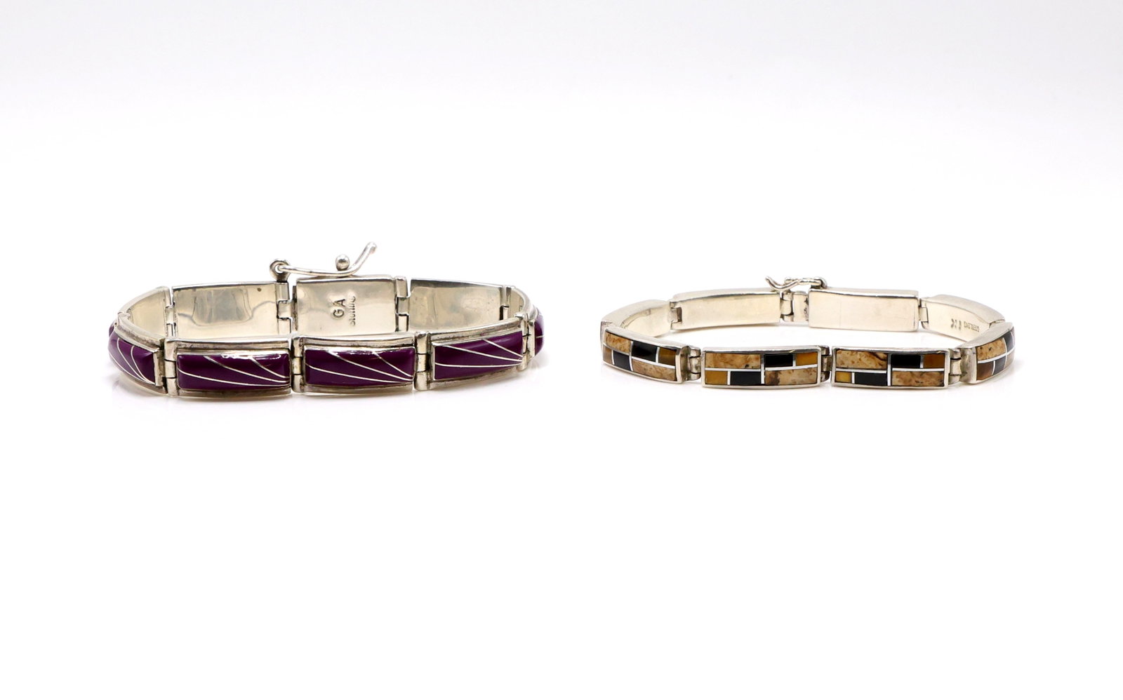 Adakai & Kee Sterling Silver Bracelets: Two sterling silver bracelets, Gilbert Adakai bracelet with magenta turquoise and linear silver inlay, 7.25" long x .38"h, .85 ozt; and an Ivan & Inez Kee bracelet with jasper, jet, and tiger's eye ge