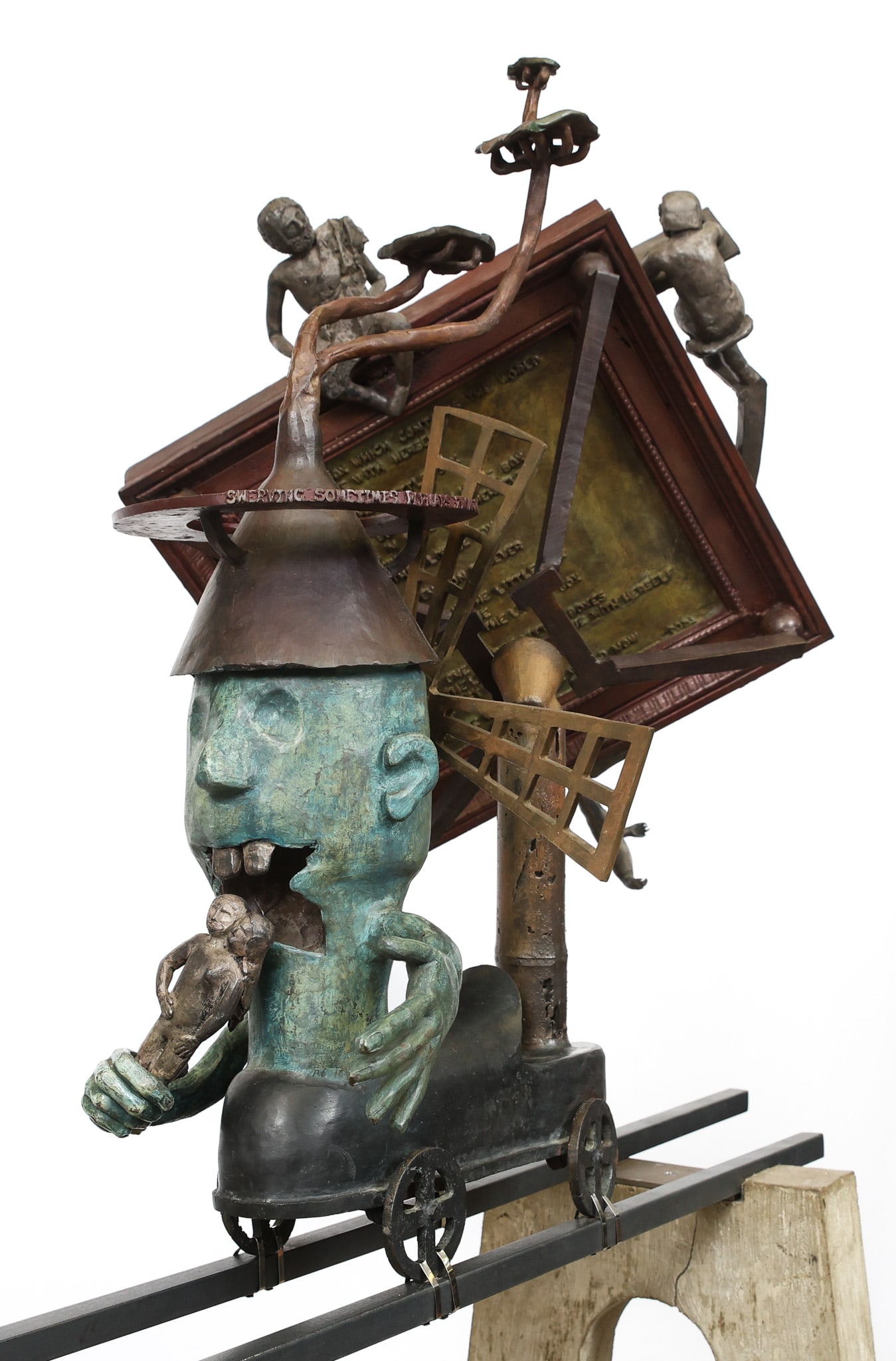 Surrealist Mixed Media Sculpture: Bronze sculpture, "Serving Sometimes Perhaps for Joy", a patinated mischievous figure with protruding kinetic windmill, connected to a painted plaque with poetry by Vasko Popa and figurals. Sculpture 