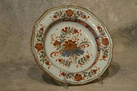 Faience Pottery Plate.: Deep plate form decorated with hand-painted floral design, scalloped rim. 8 3/4" dia.