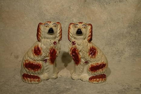 Pair of Staffordshire Dogs.: Spaniel form in red and white hair. With painted eyes and facial features. 12" t. Condition: Crazing and minor paint touch-up.