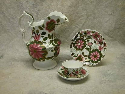 Gaudy Ironstone Lot.: Lot includes large pitcher, plate, and cup & saucer. All decorated with pink and green floral design with copper luster accents. Pitcher 10 1/2" t., plate 7 1/2" dia., saucer 5 3/4" dia., and cup 2