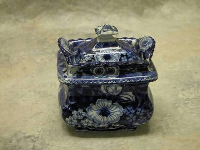 Historical Blue Sugar Bowl.: Dark blue transfer of flowers in basket, unmarked. 5 1/2" t., 5" w. Condition: Chip on lid, repair and large chip on interior rim of bowl.