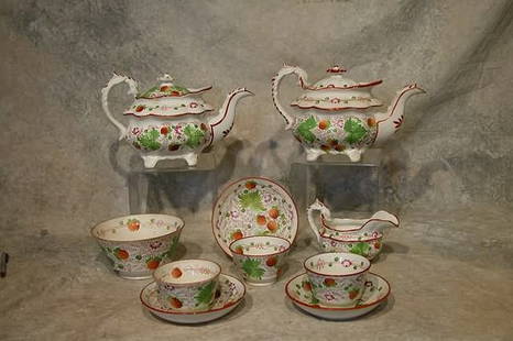 Soft Paste Tea Service.: Includes 2 tea pots, creamer, waste bowl, and 3 cups and saucers. All decorated in "Strawberry" pattern. Tea pots 7" t., creamer 4", waste bowl 6" dia., 3 1/2" t., saucers 5 3/4" dia., cups 2 1/2" t.