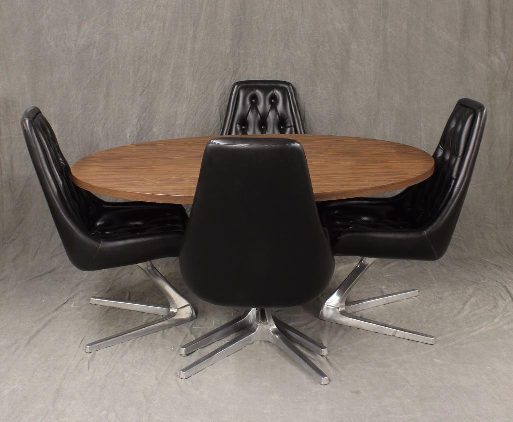 Chromcraft "Sculpta Star Trek" Dining Table & Chairs: Set includes four black leather chairs with metal "Star Trek" bases and oval laminate dining table with metal pedestal base. Table measures 28"h x 59.5"w x 44.5"d. Chairs meas