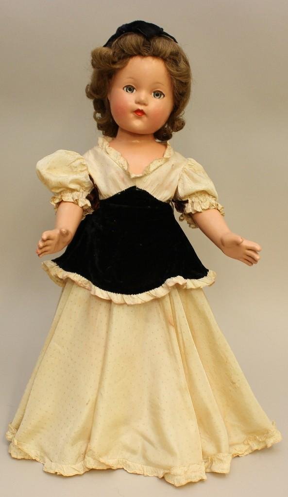 21" ALL ORIGINAL COMPOSITION EFFANBEE 1935-1940 "ANNE: Blue sleep eyes, brown human hair wig. Dressed in original ivory tafetta gown with black velvet midriff, attached pink petticoat and pink panties. Green oilcloth sandals, socks. Stand. Condition: ligh