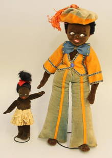 PAIR OF ALL ORIGINAL ENGLISH TAGGED BLACK VELVETEEN: 7" NORAH WELLINGS ISLAND GIRL AND 14 1/2" FARNELL'S ALPHA TOYS MALE. Both dolls have painted side glance eye, black mohair wigs. 7" Doll - is wearing a grass hula skirt. 14 1/2&quo