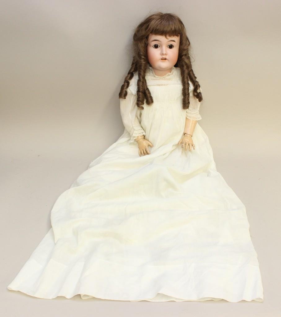 29" 32 )K/7( ANTIQUE BISQUE HEAD DOLL.: Brown sleep eyes, open mouth, synthetic wig. Papier mache ball jointed body. Dressed in antique white cotton baby gown, long petticoat, pantaloons, ribbon trimmed lace cap. Child's black and white 3-b
