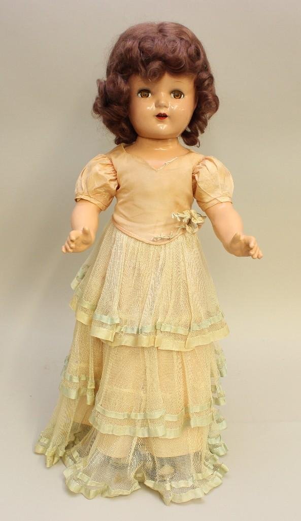 22" IDEAL COMPOSITION DOLL WITH PERIOD CLOTHING.: Brown sleep eyes, open mouth, beautiful uncombed curly brown mohair wig. Dressed in either an original unmarked Ideal dress or an original unmarked Effanbee dress of tiered gathered tulle over pink ta