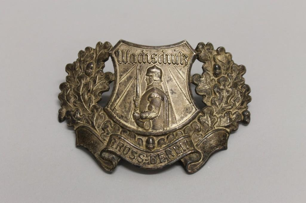 German WW I schako frontal plate for Berlin Watch unit.: German WW I schako frontal plate for Berlin Watch unit. Lot consists of a stamped silver schako plate presenting an armored and helmeted warrior holding a sword below the word"Wachschutz" wi