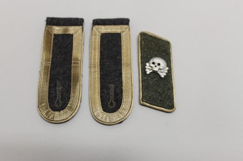 German WW II shoulder boards and single collar tab of: German WW II shoulder boards and single collar tab of the Hermann Goering division. The NCO shoulder boards are of Luftwaffe grey wool facing which is surrounded by silver tress with white piping. Col