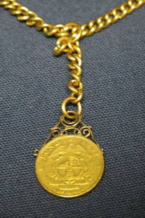Watch Chain with Fob.: Coin "Zuid Afrikaansche Republiek 1-Pond-1897". Chain marked "18K"on clasp. 18" long. 37.8dwt.