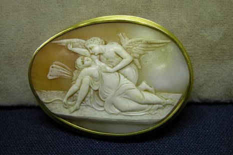 Cameo Pin/Pendant.: Oval pin decorated with angels in allegorical scene, in 14K yellow gold frame.