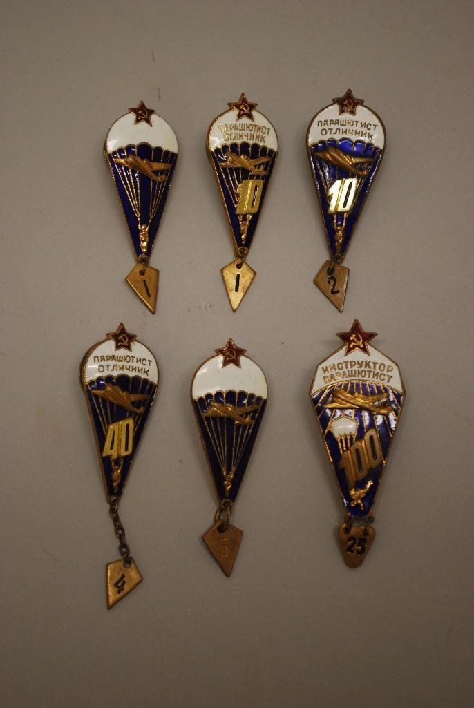 Grouping of Soviet Parachutists Badges: Grouping of Soviet parachutists badged indicating number of jumps completed including; 125, 44, 12, 11, 5, and 1. Badges exhibit some enamel scuffing. 6 pieces.