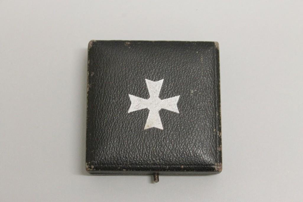 German WW II cased War Merit Cross 1st Class without: German WW II cased War Merit Cross 1st Class without swords. Medal is equipped with a coke bottle shaped pin, stamped "L 15" (Otto Schickle). Medal is housed in a black leatherette case with