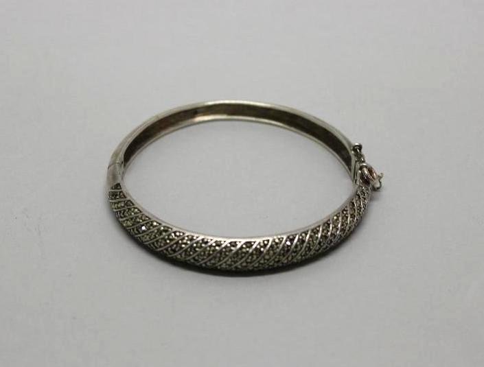 Marcasite Bracelet: Sterling. Hinged bangle missing safety chain but includes spring ring. 2 1/4" I.D. Missing one end Marcasite. 21.6gtw.