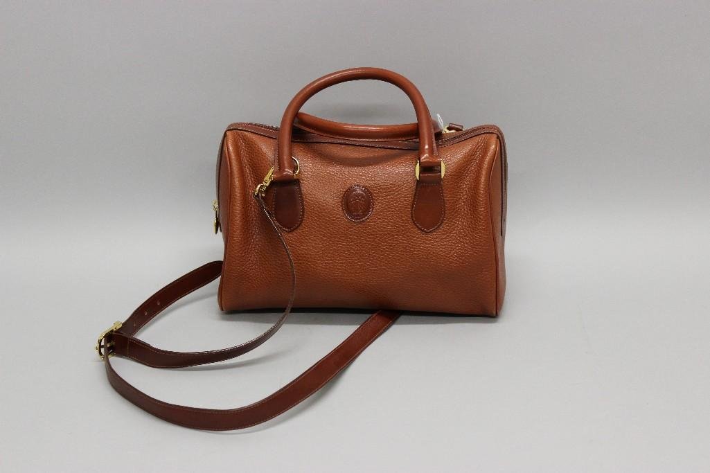 Mark Cross Crossbody Satchel: Reddish-brown pebble leather bag with top zip closure, gold tone hardware, and detachable shoulder strap. Leather lined interior with side zip pocket. Marked "Mark Cross New York est. 1845"