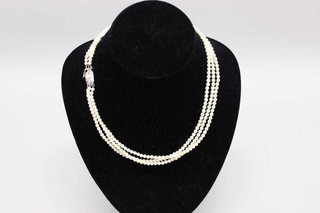 Pearl Necklace: Mikimoto. 18" long triple strand of 3.5-4.0mm round Pearls features a Silver pressure tongue clasp with (1) 4.4mm round Pearl and safety catch. 29.2gtw