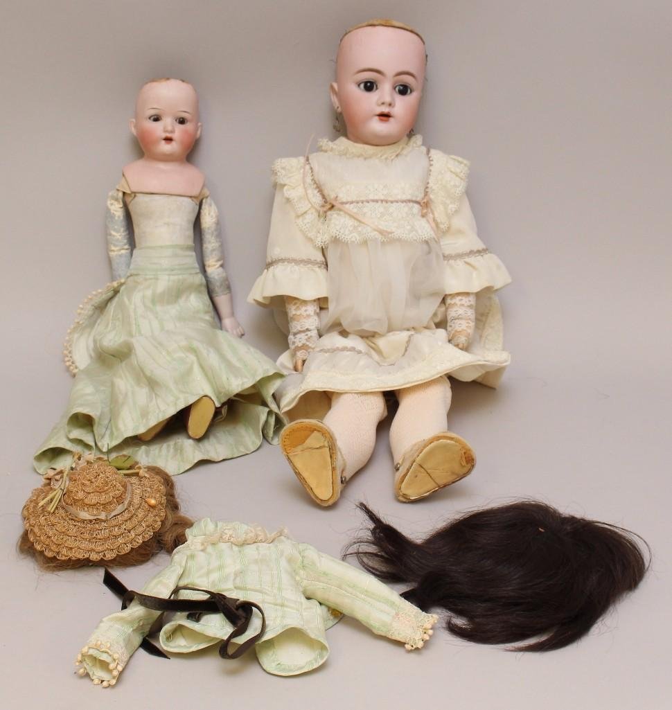 BODY PARTS: PAIR OF ANTIQUE BISQUE HEAD DOLLS.: 22" 111 1/2 99 DEP Germany H 3. Sleep eyes, open mouth, pierced ears, human hair wig. Papier mache ball jointed body. Newer clothing. Condition: teeth missing. Neck socket has been rebuilt. 16&qu
