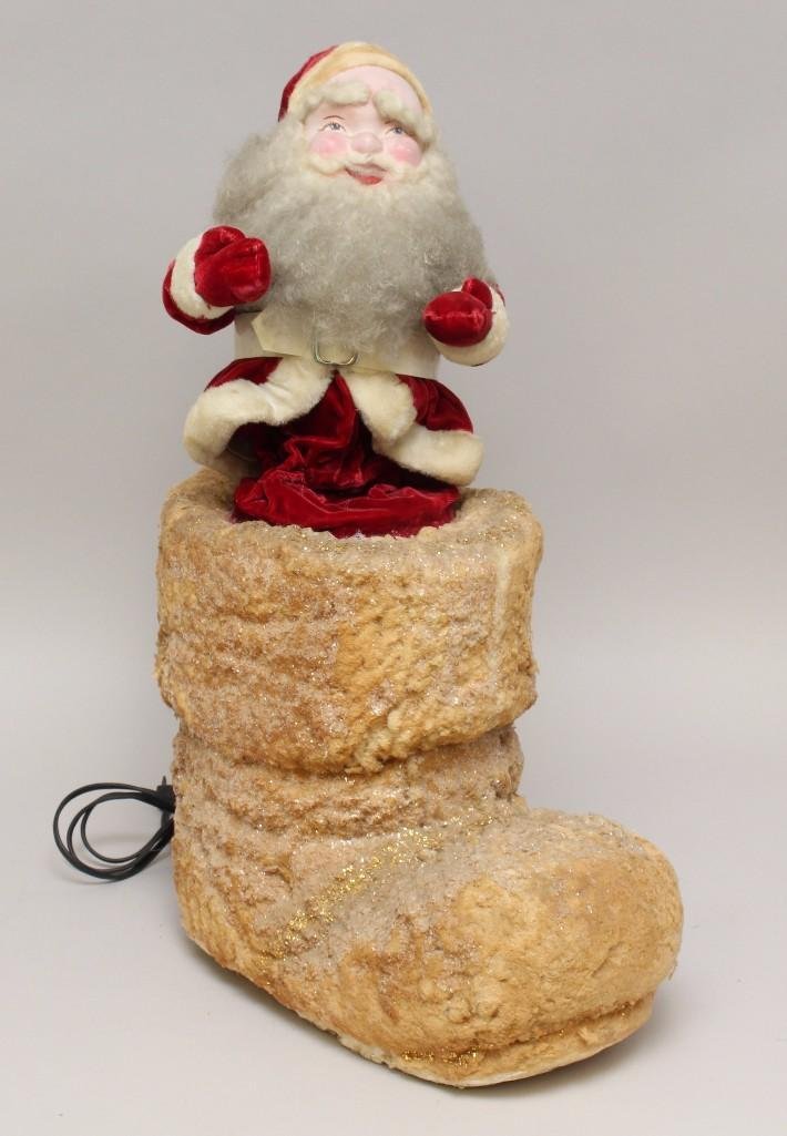 VINTAGE SANTA.: 1950's(?) Santa popping out of a large white boot. Santa is 11". Overall height 21". Santa has a papier mache face, long white curly mohair beard, eyebrows, mustache. Dressed in red velvet s
