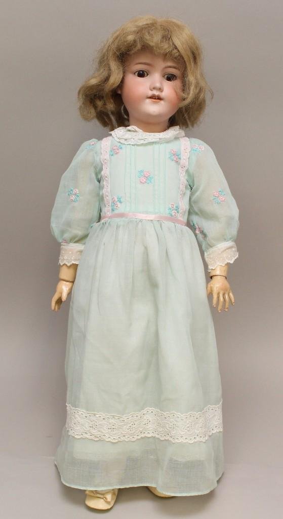 26 1/2" MADE IN GERMANY ARMAND MARSEILLE 390n.: Brown sleep eyes, open mouth, honey blonde human hair wig. Papier mache ball jointed body. Dressed in newer clothing, shoes/socks. Condition: small mold imperfection at corner of mouth.