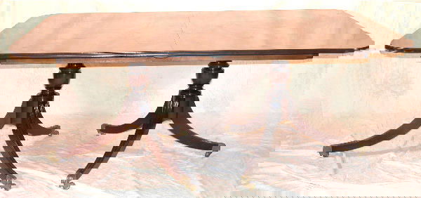 Mahogany Dining Table.: Two-pedestal banquet table with vase turned pedestal bases supported by Duncan Phyfe triphid base, Saybolt and Cleland "Addison" model, American, 20th Century, 72"l., 50"w., along with two 24" leaves.