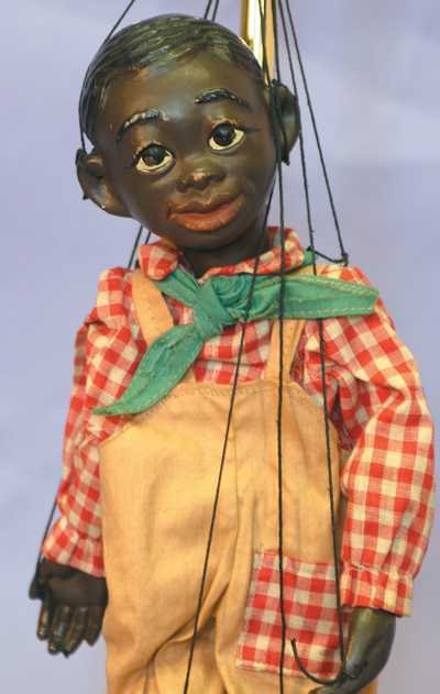 Black 14" F&B Marionette © Lucifer-V Austin: 14" Effanbee black marionette marked © Lucifer - V. Austin. Composition head and lower limbs. Young man in plaid shirt, tan overalls. Felt hat is missing. Minor paint loss on face around eyes, nose a