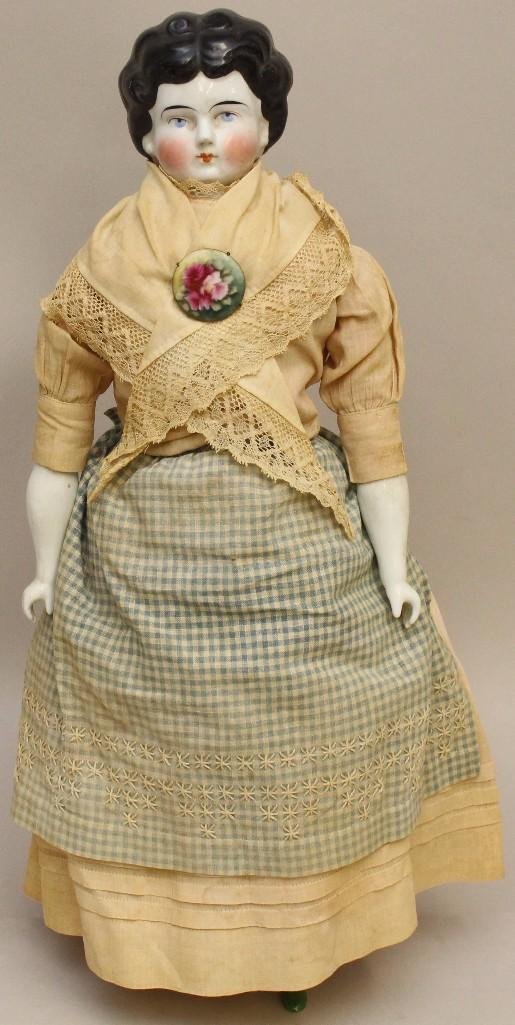 21" ANTIQUE CHINA LOWBROW DOLL.: Black hair, blue eyes, nice cheek coloring. Cotton twill body may be over original cloth body. China lower limbs with green heeled boots, pink garters. Dressed in all antique clothing: pink dress, emb