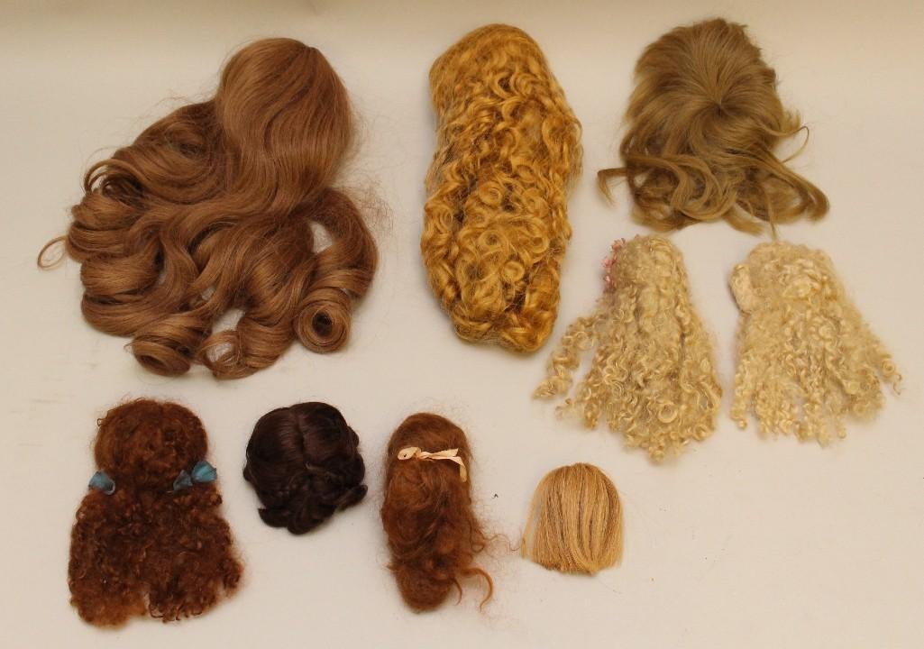 LOT OF DOLL WIGS: HUMAN HAIR, MOHAIR.: These wigs appear to have been purchased and never used on any doll. Human hair - Monique 15"-17" auburn. 10" Brown. 3" Strawberry blonde. Mohair - 16" long curly strawberry b