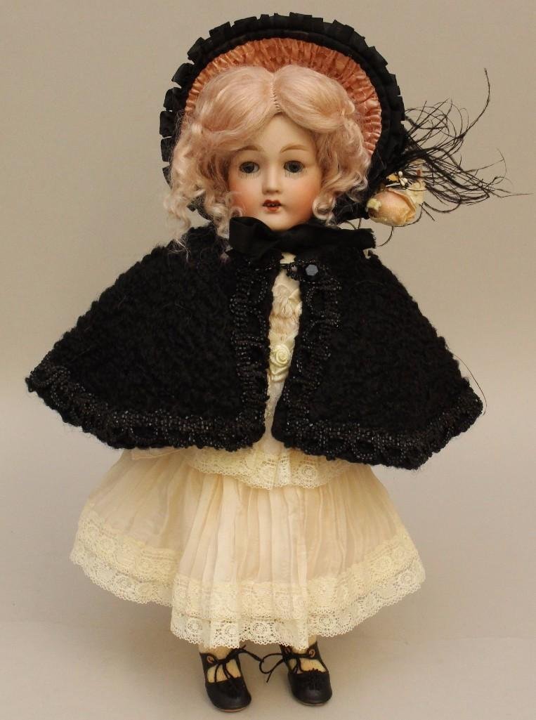 13 1/2" 10727 REVALO GERMANY 0 ANTIQUE BISQUE HEAD: Blue sleep eyes, very long lashes, open mouth, replaced mohair wig. Very clean papier mache ball jointed body. Dressed in replaced, reproduction clothing: silk dress, cotton underwear, black curly fur