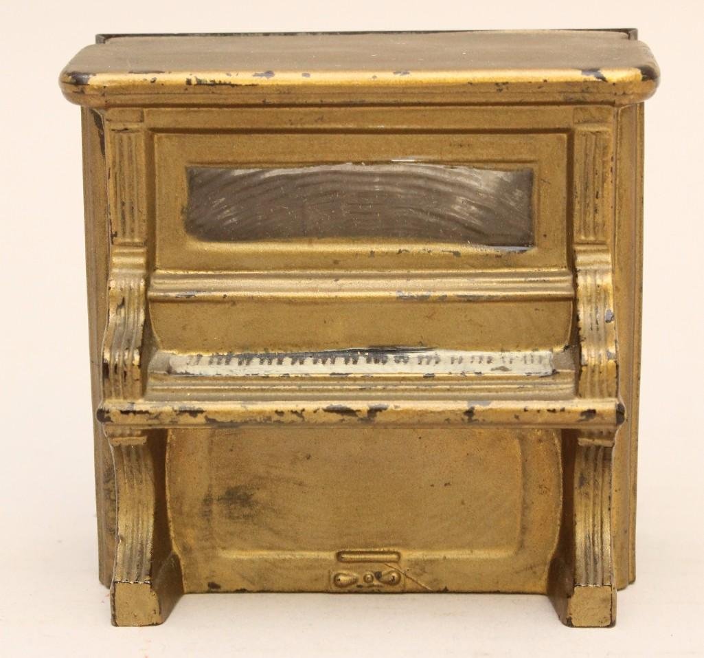 Still Bank Piano: 3 1/4 long x 1 1/4" wide x 2 3/4" tall. Glass with tin backed slot with some paint loss.