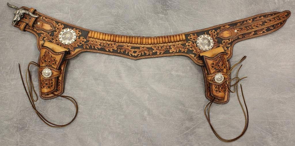 Steer Concho Carved Double Holster Gun Belt: Intricately tooled leather.