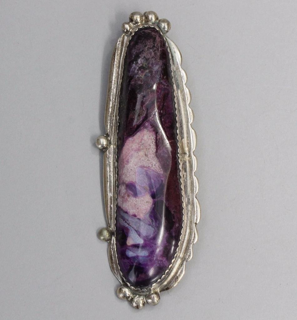 Native American Sugilte Pin: 4" x 1" sugilite stone cabbed in silver. Signed by the artist on the back.