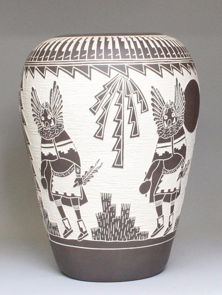 Native American Acoma Pottery: Kachina designed pottery vase. Approximately 15" tall x 34" in circumference. Signed "M. and R. Rumero."