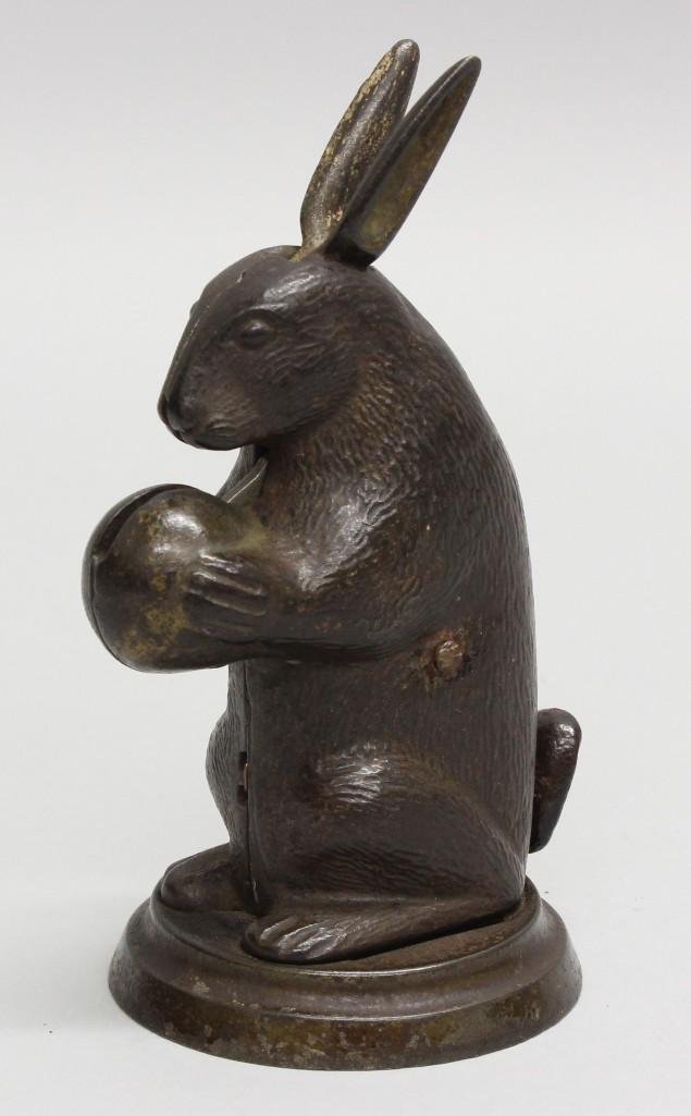 Lockwood Manufacturing, Rabbit Standing, Mechanical: Cast iron mechanical bank manufactured by Lockood Company, South Norwalk, Connecticut circa 1882. Coin between the paws of the rabbit and press the tail, ears wiggle and the