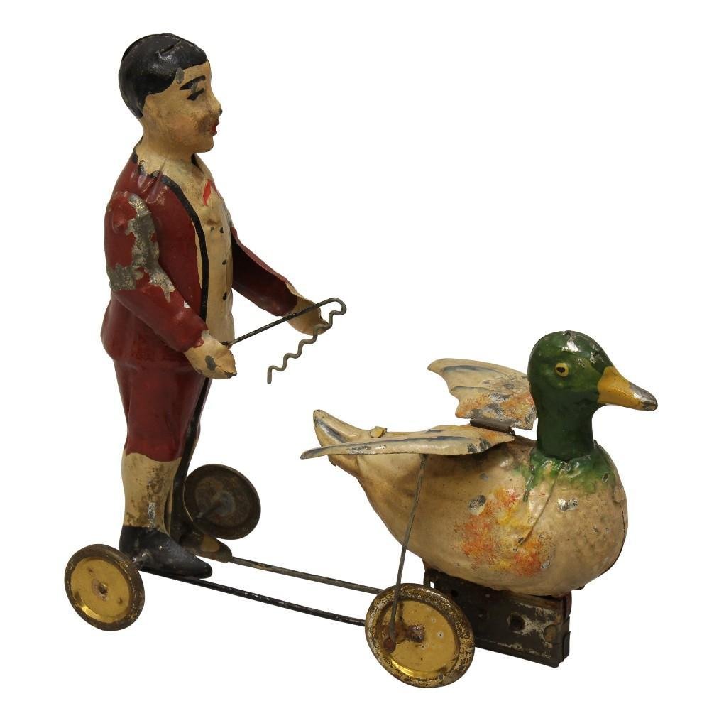 Boy with Duck, Tin Litho, Wind Up Toy: Tin litho, wind up toy of boy walking with pet duck. Marked "Germany" under ducks left wing. 6.75"h x 6.75"w x 3.25"d
