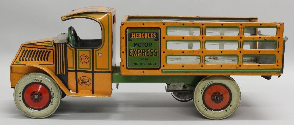J. Chein, Hercules Pickup Truck, Wind Up Toy: Wind up toy tuck manufactured by J. Chein & Co. Orange tin litho. Back gate opens. 8"h x 19"w x 7"d.