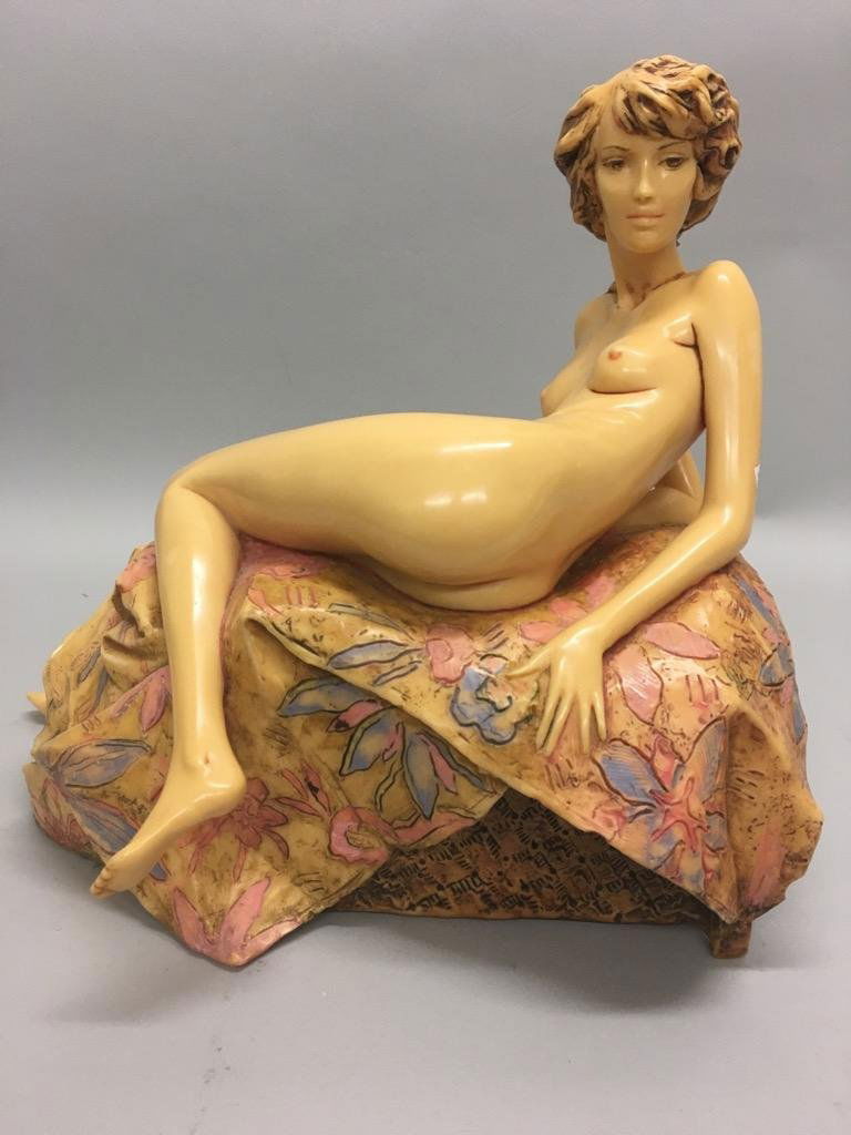 Frank Gallo (b 1933, Illinois, Ohio) "Awakening Beauty": Resin sculpture of reclining nude, with textured floral base. Signed "Frank Gallo, 85/300" at lower left. 14"h x 16.5"w x 9.75"d